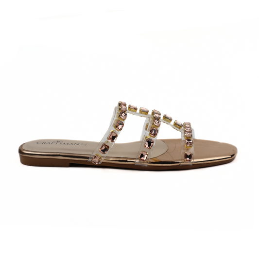 Gold sandal with gemstones on a white background
