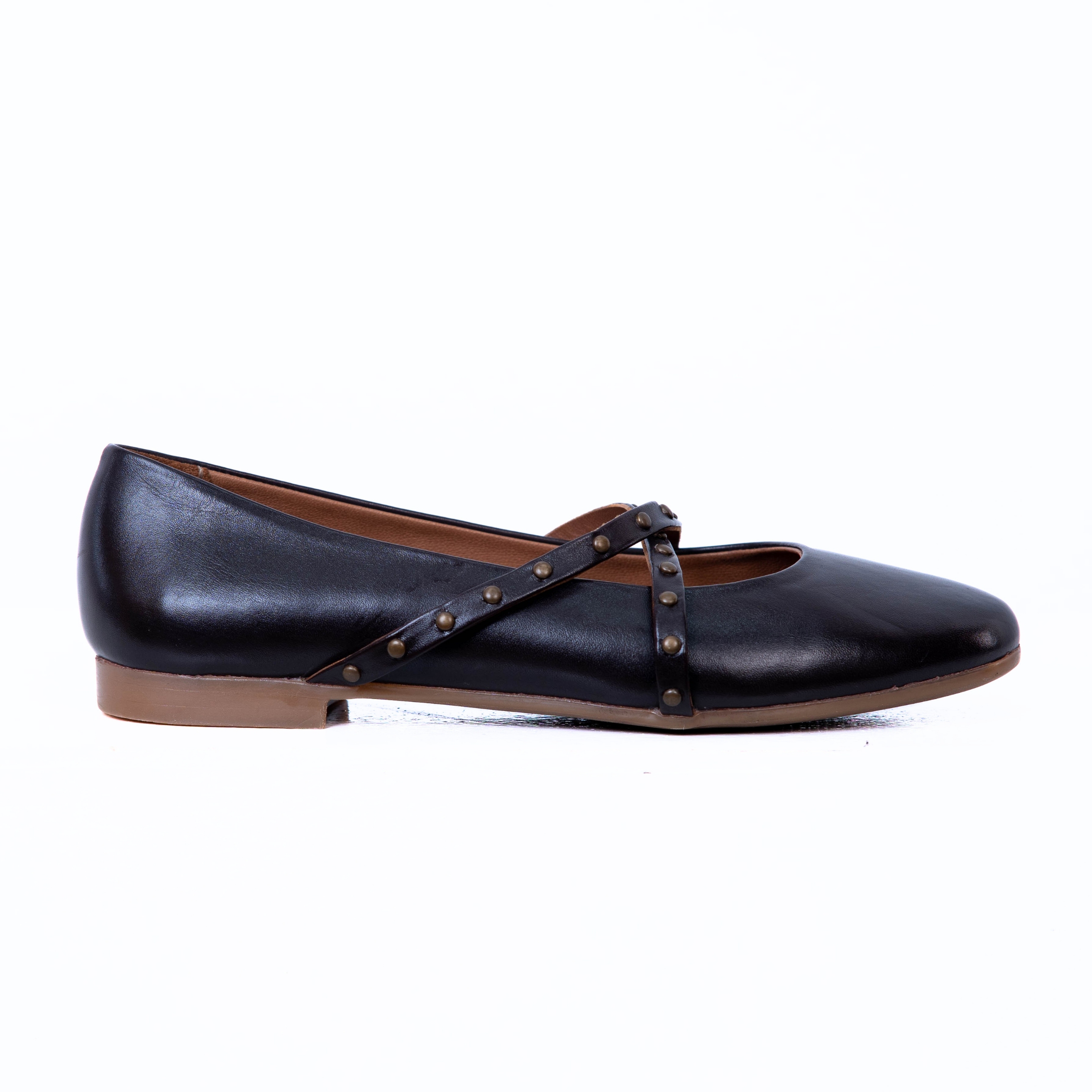 A black leather flat shoe with a pointed toe, a brown sole, and a decorative strap across the instep adorned with brass studs, shown in profile against a white background.
